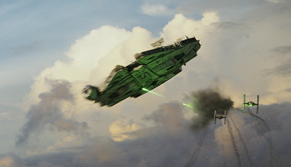 A large green spacecraft and two smaller green starfighters fly through a cloudy sky.