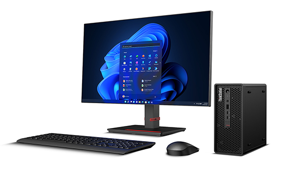 A desktop computer featuring a large monitor, a black keyboard, a wireless mouse, and a small black tower.