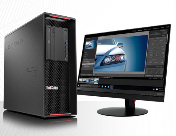 A black Lenovo ThinkStation tower next to a wide monitor showing a car photo being edited.