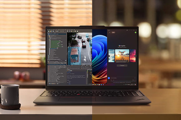 A laptop on a desk showing a split screen of programming code and a vibrant blue and orange wallpaper.