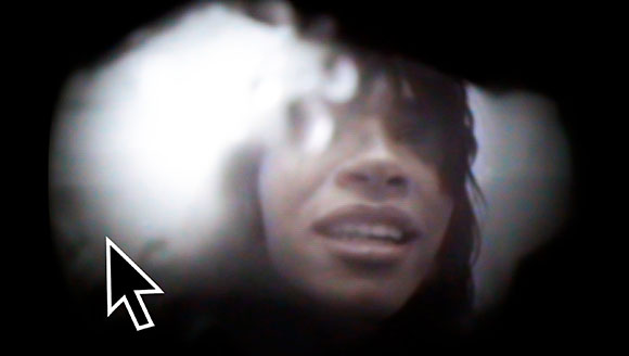 A blurry, black and white close-up of a person's face seen through a circular vignette.