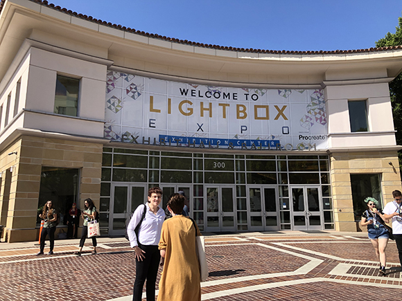 Exterior of the Lightbox Expo Exhibition Center with a banner reading "WELCOME TO LIGHTBOX EXPO" and people walking on the br