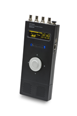 Black handheld electronic device with a small digital screen, blue indicator lights, and a large circular dial.