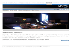 A large audio mixing console with multiple sliders and illuminated buttons in a dark studio.