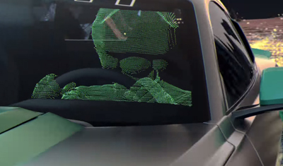 A green digital point cloud scan of a person sitting in the driver's seat of a car.