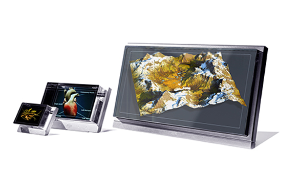 Three electronic screens of different sizes displaying a mountain landscape, a human heart, and a microscopic organism.