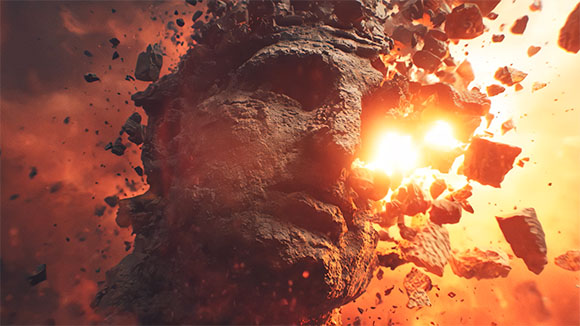 A large stone sculpture of a face shattering into pieces amidst bright orange fire and glowing embers.