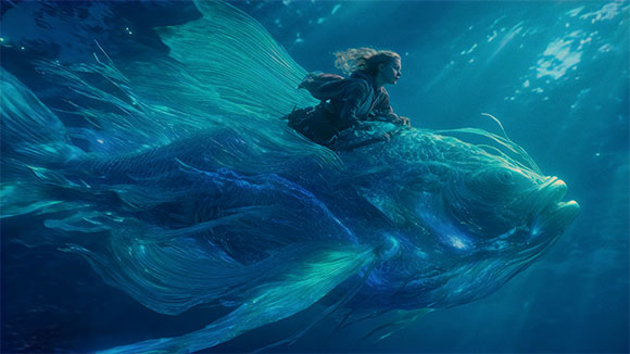 A person riding on the back of a large, bioluminescent fish swimming through deep blue water.