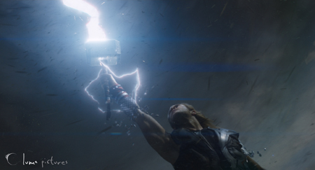 A man reaches upward toward a hammer crackling with white lightning against a dark, stormy sky.