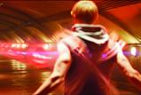 A person seen from behind with motion blur in a tunnel illuminated by red light.