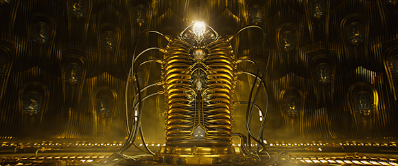 A glowing, golden mechanical structure with ribbed details sits in a dark, patterned hall.