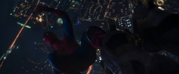 Spider-Man in mid-air against a backdrop of city lights at night.