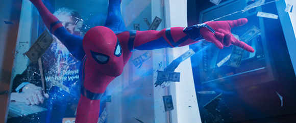 Spider-Man in a red and blue suit swings through a room as dollar bills fly through the air.