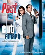 A man in a suit holds a shoe and a woman in a white jacket holds a gun, posing back-to-back.