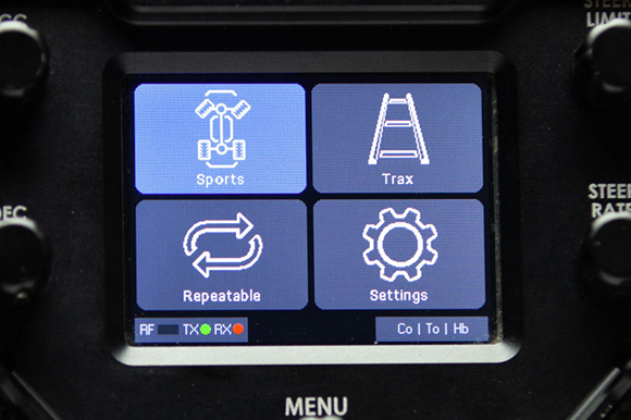 A digital interface displaying four blue square icons for Sports, Trax, Repeatable, and Settings.