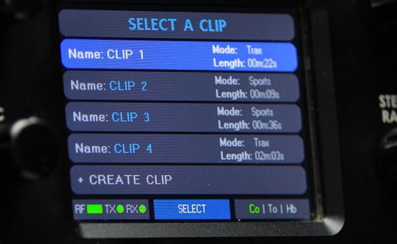 A close-up of a digital display showing a menu titled SELECT A CLIP with four clip options listed.