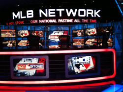 A television studio set for MLB Network featuring multiple digital screens and bright red lighting.