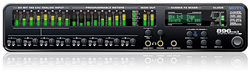 Black audio interface with green LED level meters, various control knobs, and a digital display.