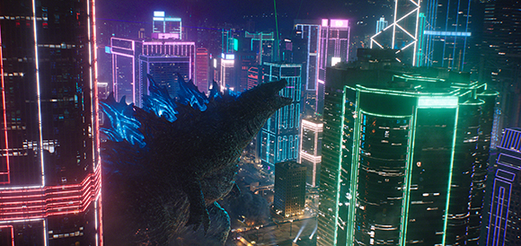 A giant reptilian monster looms over a futuristic city filled with glowing neon skyscrapers.