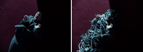 A man in a dark suit gestures intensely, followed by him draped in tangled, silvery vines.