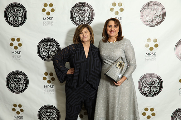 Two women standing side-by-side in front of a white backdrop with MPSE logos.
