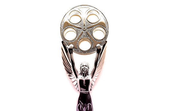 A silver trophy of a winged human figure holding a large film reel aloft against a white background.