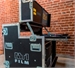 An open black professional equipment flight case with silver metal edges and the word FILM on the side.