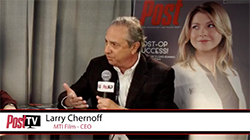 Larry Chernoff speaks into a microphone during a Post TV interview.