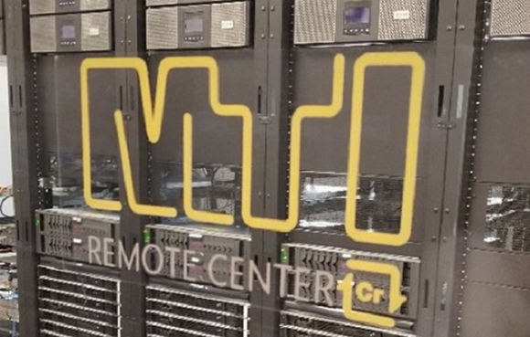 Server racks in a data center with a large yellow logo and the text REMOTE CENTER.