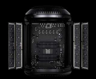 An exploded view of a computer motherboard with four RAM modules positioned on either side against a black background.