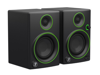 Two black studio monitor speakers with bright green circular accents around the drivers.