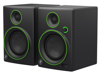 Pair of black studio monitor speakers featuring bright green circular accents around the drivers.