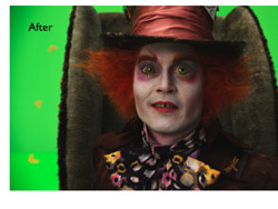 A man with wild red hair, pale skin, and green eyes wearing a large top hat and patterned clothing.