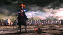A person with orange hair and dark makeup holds a sword in a barren field under a cloudy sky.