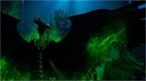 A dark-clad figure with large black wings faces a person amidst swirling green smoke.