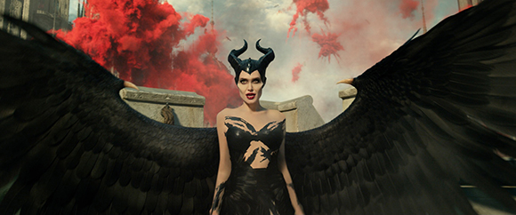 A person with large black wings and horns stands before red smoke and stone structures.
