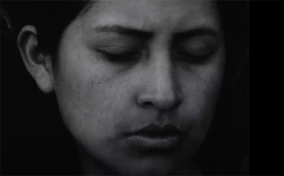 Black and white close-up of a person's face with eyes closed and a neutral expression.