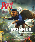 A winged monkey with a blue uniform and hat flies through a magical landscape, carrying a small, white-haired figure on its b