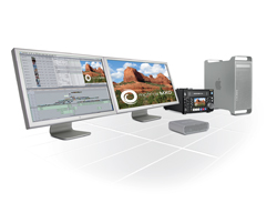 Two monitors displaying video editing software and landscape footage next to a computer tower and hardware.