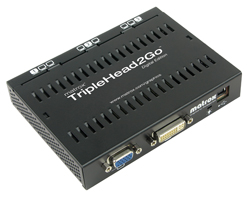 A black Matrox TripleHead2Go Digital Edition video adapter with various connection ports.