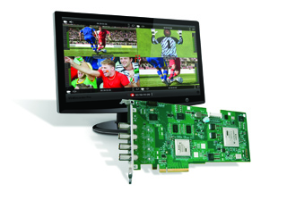 A computer monitor showing multiple soccer video feeds next to a green printed circuit board.