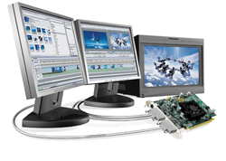 Three computer monitors displaying different digital content next to a graphics card and cables.
