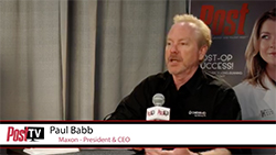 Paul Babb, Maxon President & CEO, speaking into a microphone during a Post TV presentation.