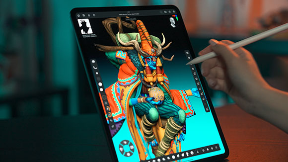 A hand uses a stylus to draw a vibrant, horned fantasy character on a digital tablet screen.