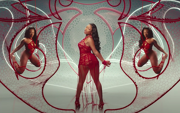 A woman in a red lace outfit appears in three poses within a symmetrical red and white geometric frame.