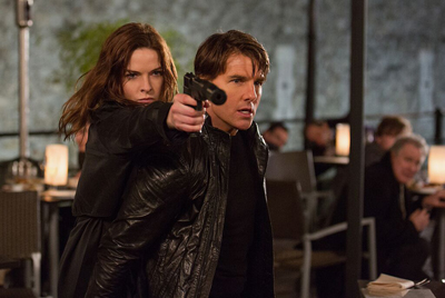 A man and woman in dark clothing aim a handgun forward in a dimly lit restaurant.