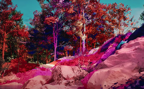 Trees with red and purple leaves stand above pink-tinted rocks and foliage under a teal sky.