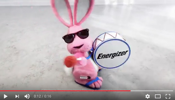A pink bunny mascot wearing sunglasses and playing a white drum with the Energizer logo.