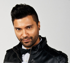 A man with dark hair and a beard wearing a black leather jacket and a bowtie.