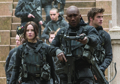 A group of people in dark tactical gear and armor walking down outdoor stone steps.